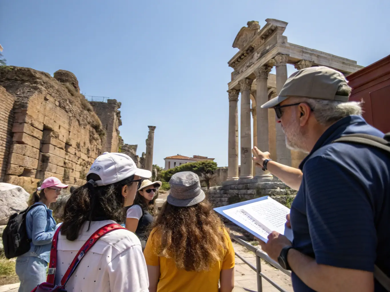 A group of volunteers participates in a guided tour of a historical monument in Ardèche, learning about its history and significance from an expert guide.